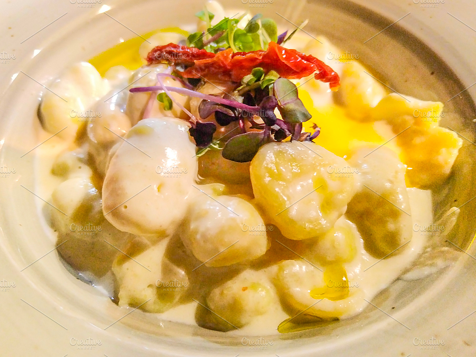 Creamy gnocchi with dried tomato and microgreens, a Food & Drink Photo by DanFLCreativo