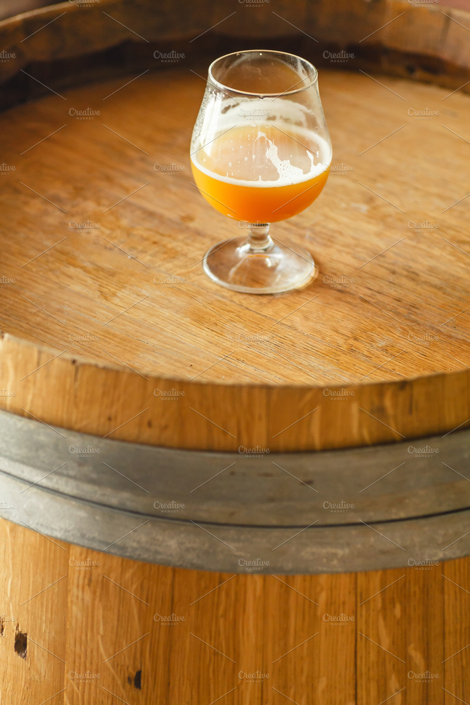Wheat ale on a wooden barrel containing alcohol, ale, and amber, a Food & Drink Photo by Hidden Hallow