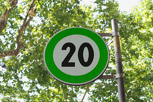 Green advisory speed limit sign, a Photo by WorldOfPhotos