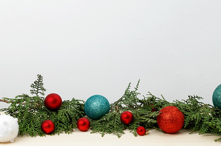 Creating a festive atmosphere, thuja branches and Christmas ornaments on a wood, a Photo by matucha