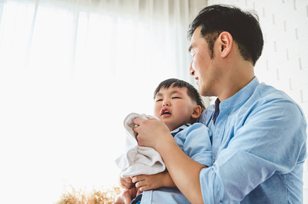 Asian Japanese father consoling his crying son and wiping tears, a Person Photo by Ministocker