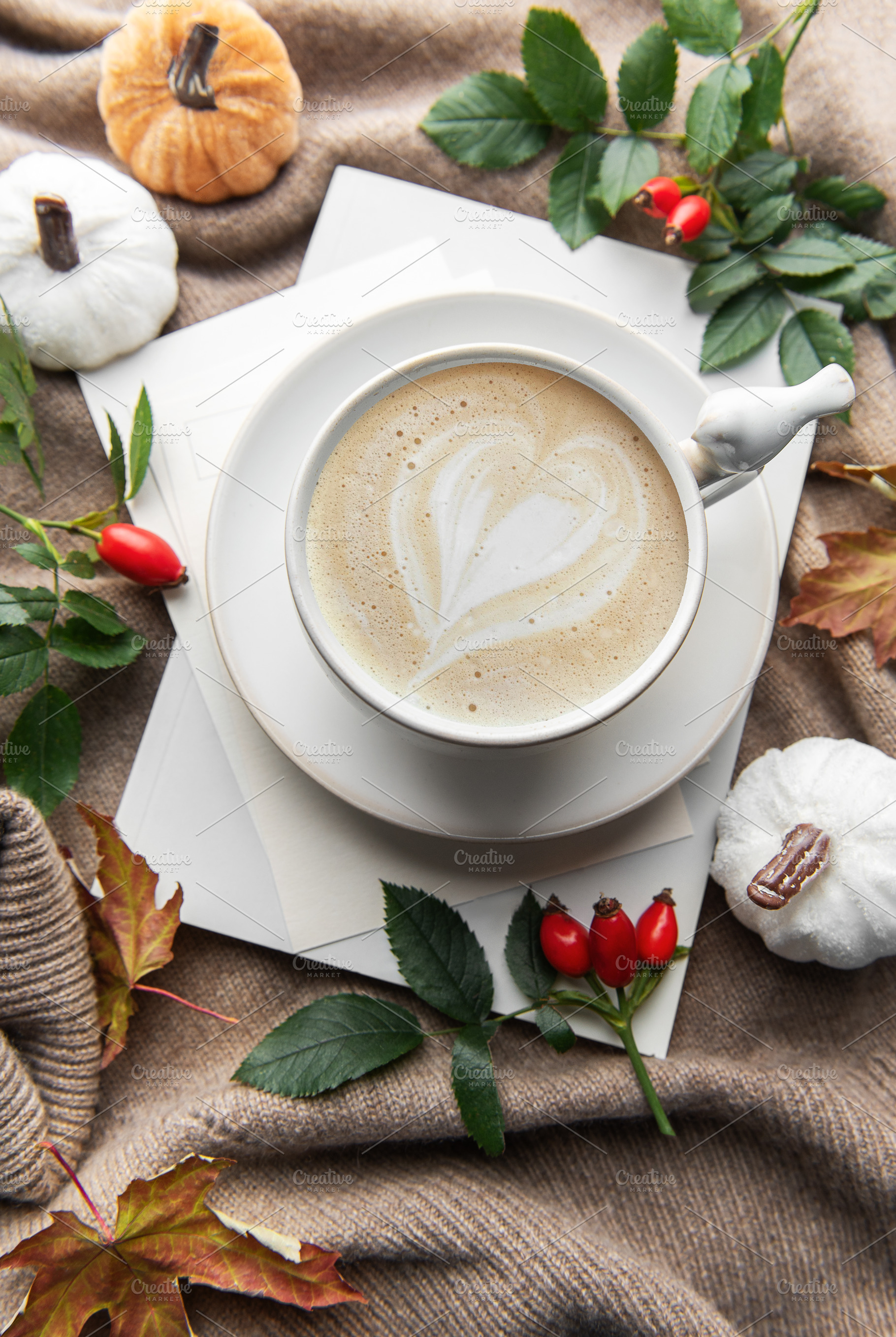Warm autumn coffee with latte art and pumpkins, a Holiday Photo by Olena Rudo