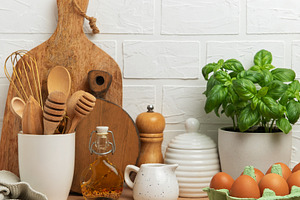 Kitchen utensils, fresh eggs, basil plant and olive oil creating, a Food & Drink Photo by Olena Rudo