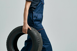 Confident Mechanic Woman Carrying Ti, a Transportation Photo by Stock Shape