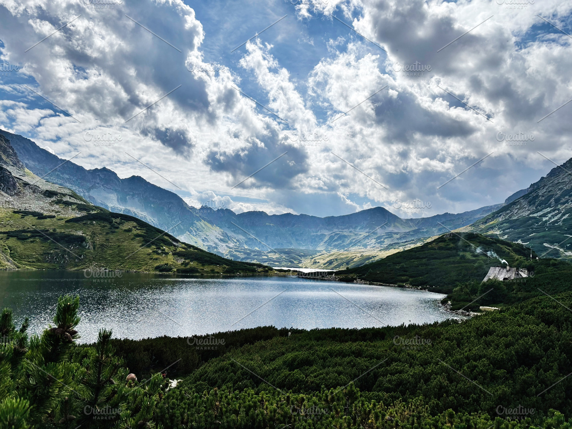Tranquil mountain lake near Zakopane Poland surrounded by green hills and drama, a Nature Photo by AS photostudio