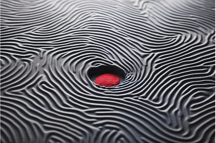 Red pill hiding in black wavy sand, an Arts & Entertainment Photo by Ylivdesign