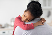 Smiling little black girl hugging her daddy, a Photo by Prostock-Studio (Thumbnail 2 of 2)