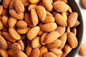 Roasted Almonds in a Bowl, top view. Flat lay, overhead, from ab, a Food & Drink Photo by LiudmylaChuhunova