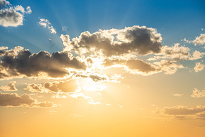 Sunset sky with clouds and sun