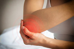 Woman Holding Painful Elbow With Red Highlight, a Health & Medical Photo by Davizro's Market