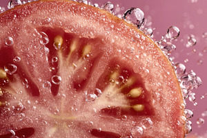 Tomato slice in bubbly water, a Photo by Beautiful things