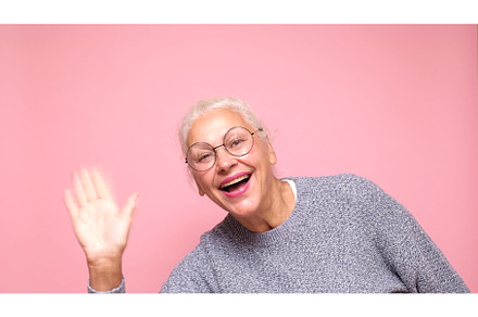 an elderly European woman greeting a