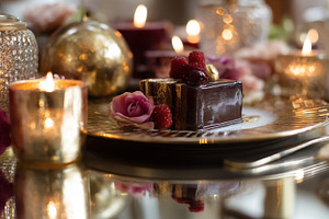 Chocolate cake with fresh raspberries and a pink rose, served on, a Photo by Studio ANNA