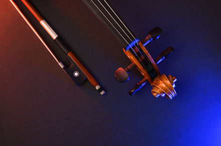 Violin headstock and bow with red and blue lights, an Arts & Entertainment Photo by Davizro's Market
