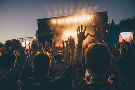 Crowd puts hands up at festival