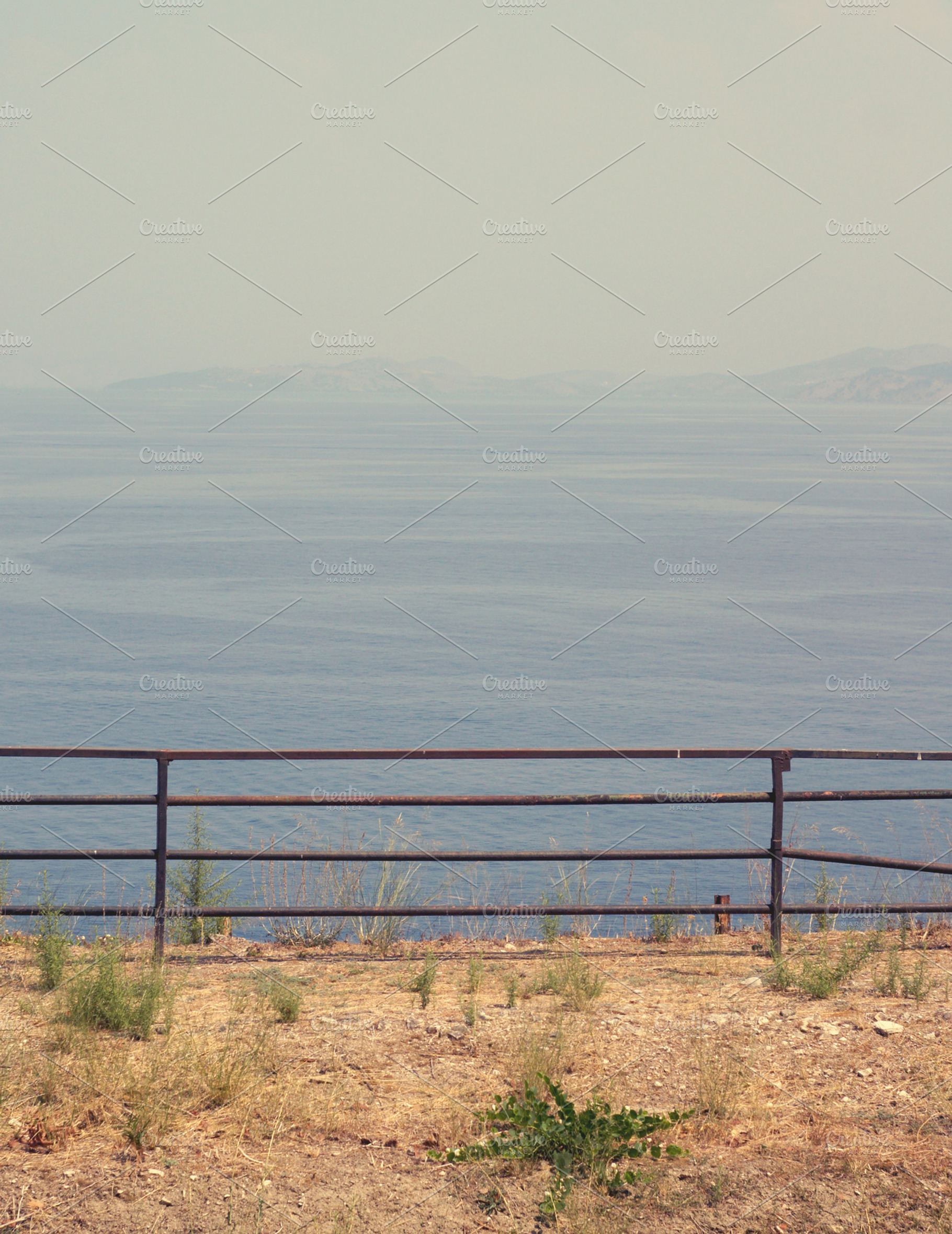 Fence containing rail, sea, and steel