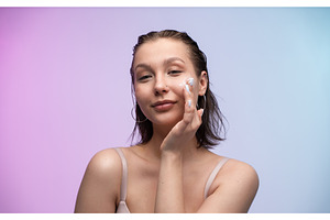 Young woman applying face, a Health & Medical Photo by volodymyrshtun13795