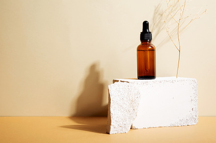 Bottle dark glass with dropper on beige background. Natural cosm, a Beauty & Fashion Photo by matucha