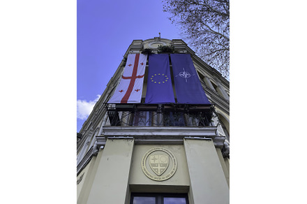 Flags displayed on a historic, an Architecture Photo by Media Whale Stock