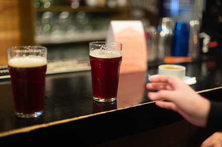 Beer glasses with dark beer are on t containing beer, glass, and alcohol, a Food & Drink Photo by oleghz