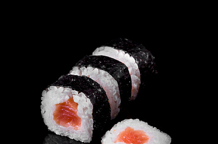Makis tuna sushi on black ground, a Food & Drink Photo by Zama Studio