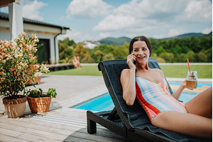 Young woman in swimsuit sitting by