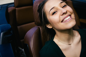 Woman smiling in a convertible car stock photo containing adult and attractive