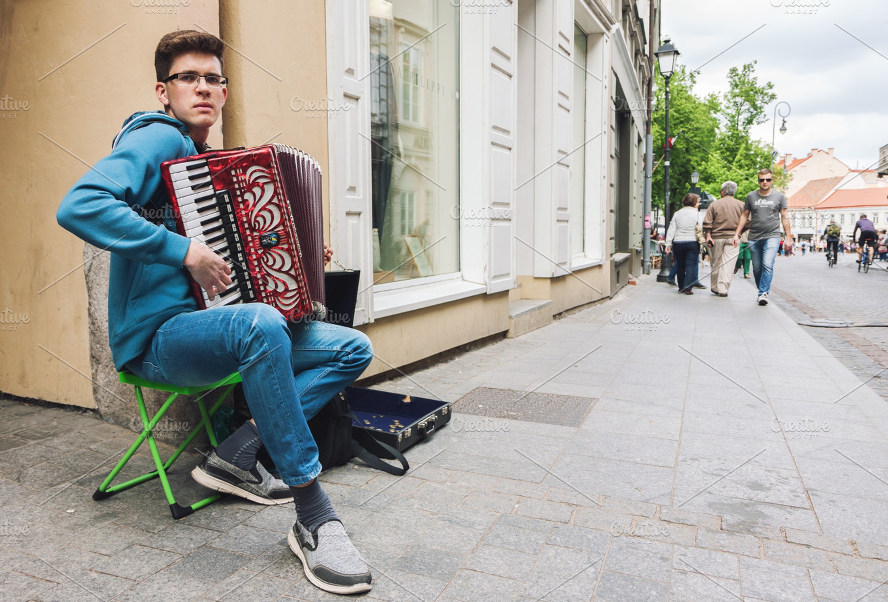 Young man playing accordion, a Person Photo by BOOCYS