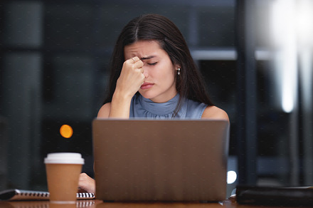 Stress, woman and night business on laptop in office with headache, doubt and depression. Tired worker, burnout and working late with mistake, anxiety and fatigue of crisis, pain and mental health, a Photo by Peopleimages.com