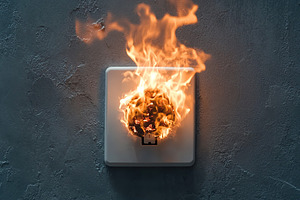 Burnt electric plug socket with smoke and fire flames, a Background Photo by AlyaAnd