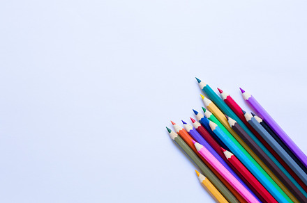 Set of coloured pencils on white featuring table, desk, and draw