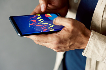 Man working with graphs on a device