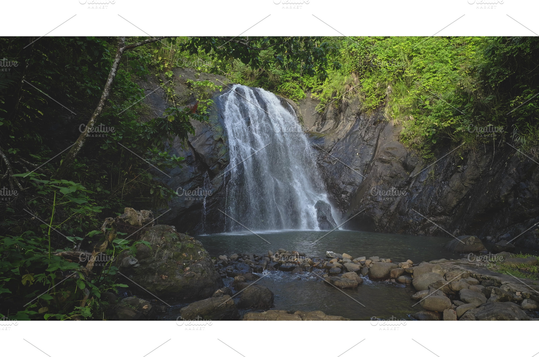 Majestic waterfall cascading into a, a Nature Photo by Goinyk