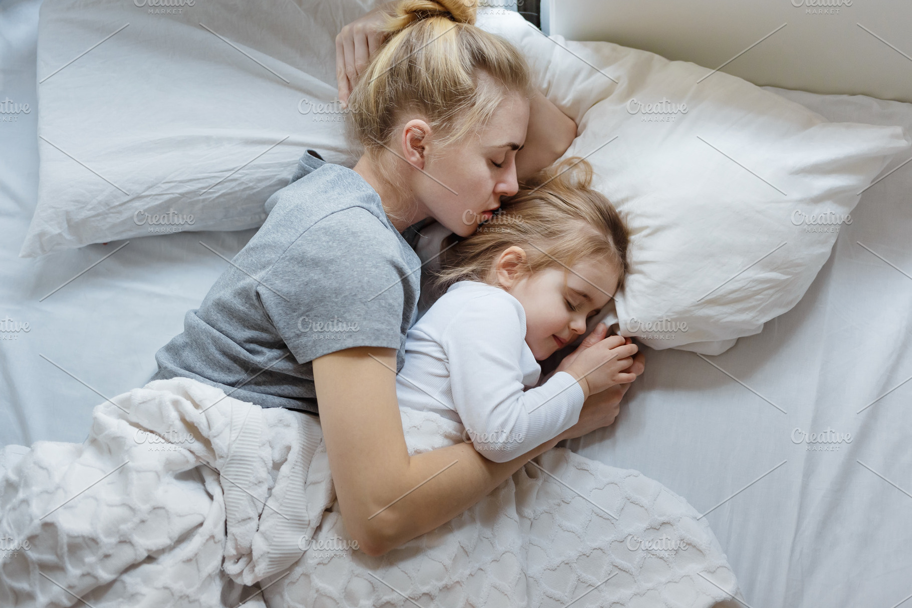 Mother and daughter sleep in bed containing fondness, lifestyle, and nap, a Person Photo by Tinyakov Story