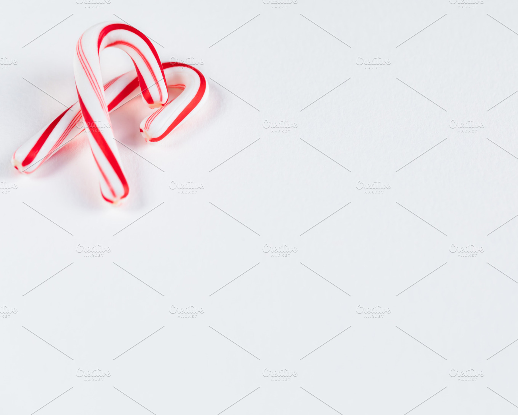 Candy Cane on White Background, a Holiday Photo by kissandmockup