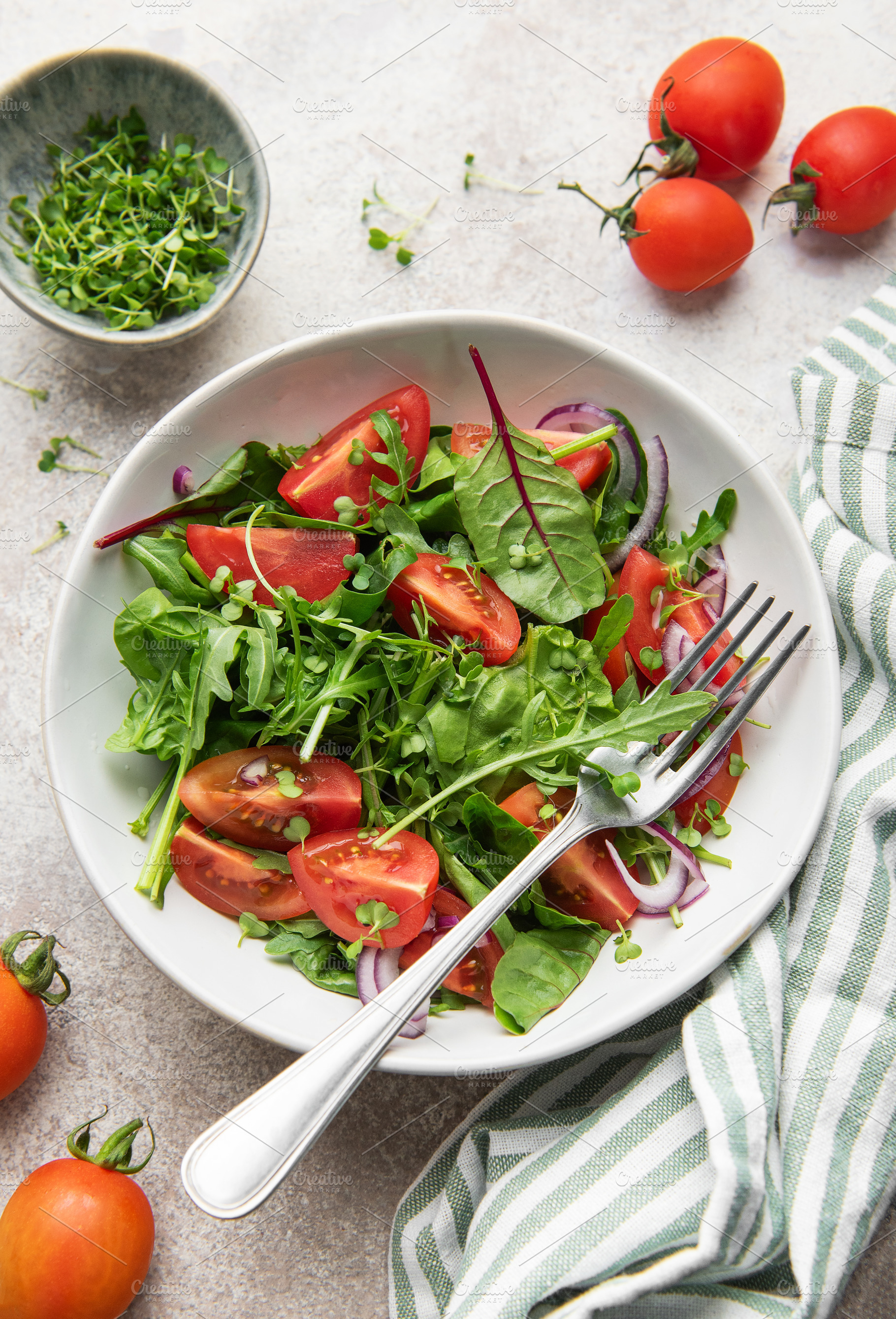 Fresh green salad with tomatoes and microgreens, a Food & Drink Photo by Olena Rudo