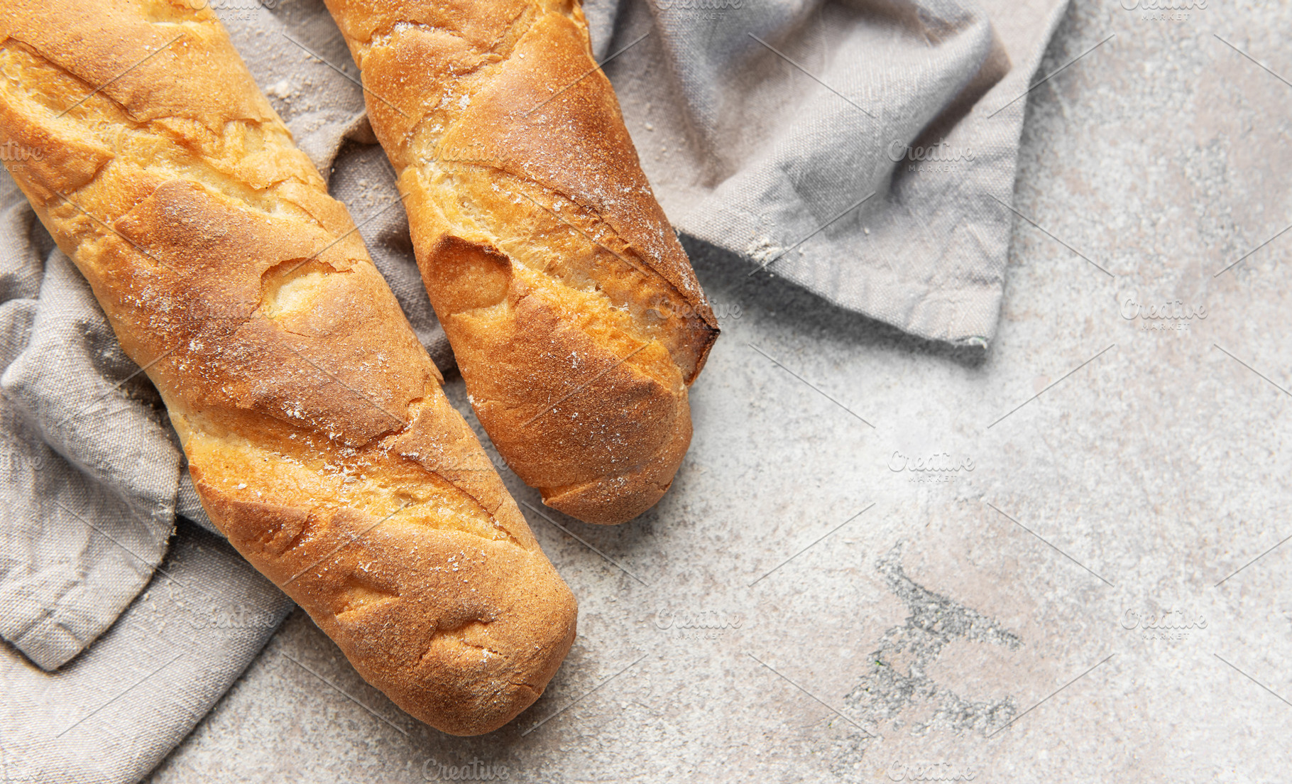 Fresh crisp baguettes on rustic linen cloth, a Food & Drink Photo by Olena Rudo