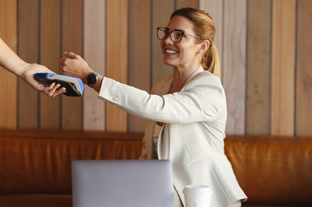 Woman making a payment using a smartwatch in a cafe, a Person Photo by Jacob Lund