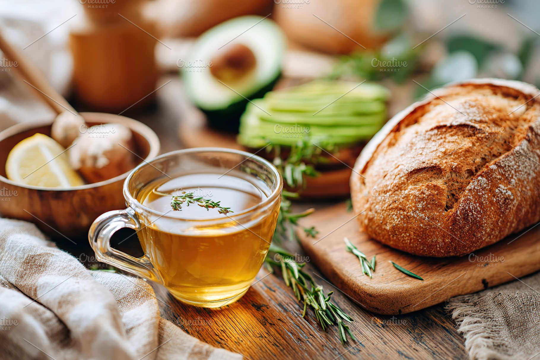 Freshly baked bread with herbal tea and avocado on a cozy breakfast table, a Food & Drink Photo by AlyaAnd