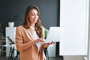 Young businesswoman near window