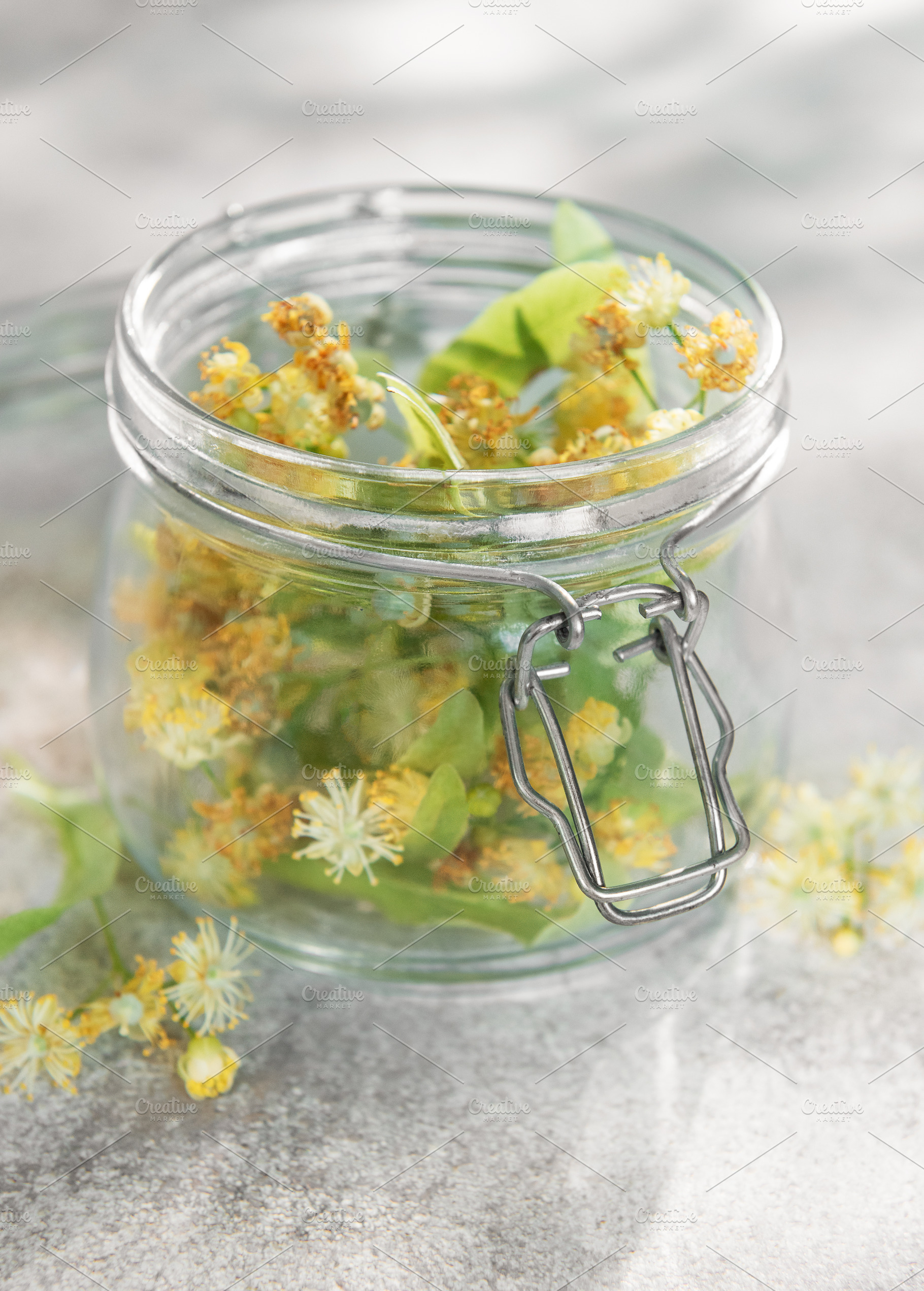 Linden blossoms filling glass jar for herbal medicine, a Nature Photo by Olena Rudo