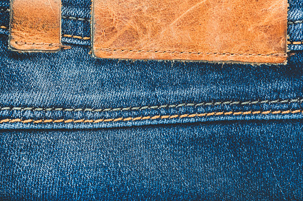 Denim background blue jeans with a brown leather label empty space featuring, a Beauty & Fashion Photo by Marmoset's Market