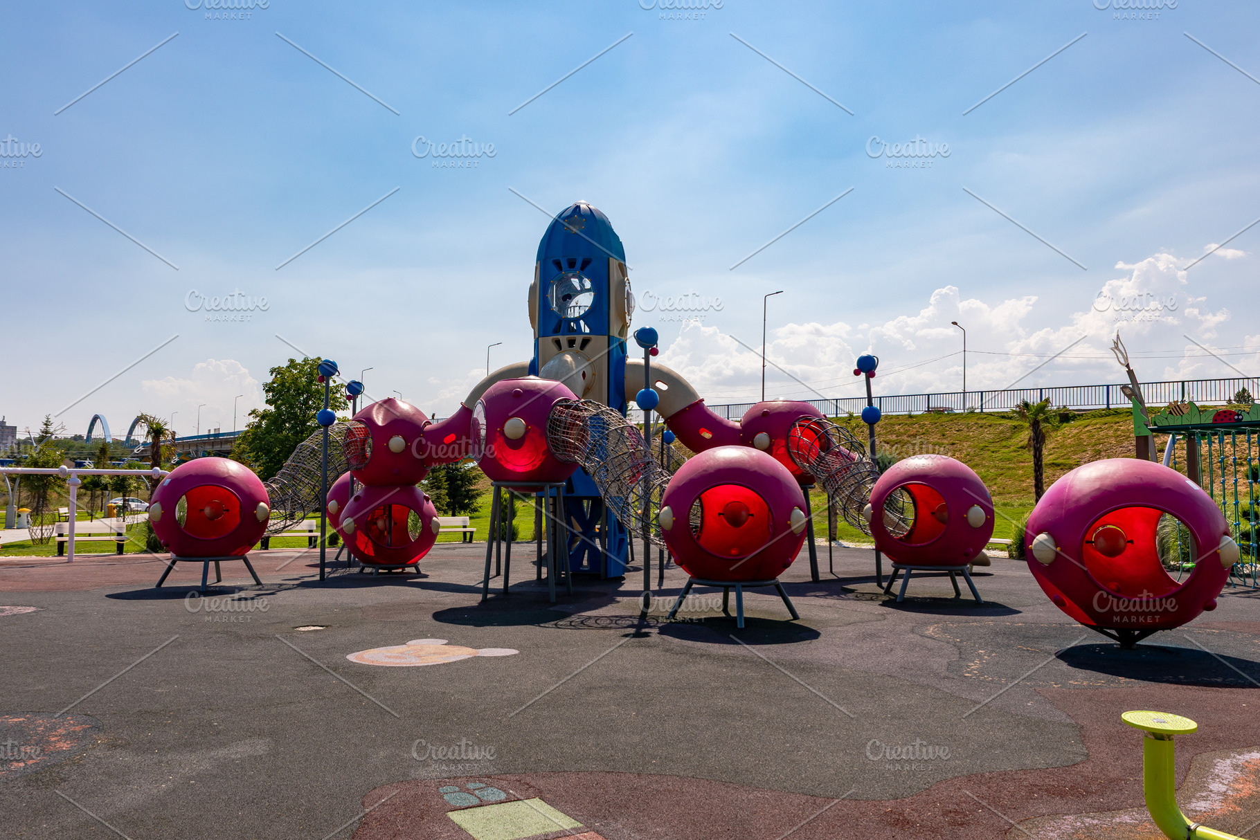 Colorful, futuristic playground equipment with red spheres and blue rocket in a, a Sports & Recreation Photo by Ales Munt