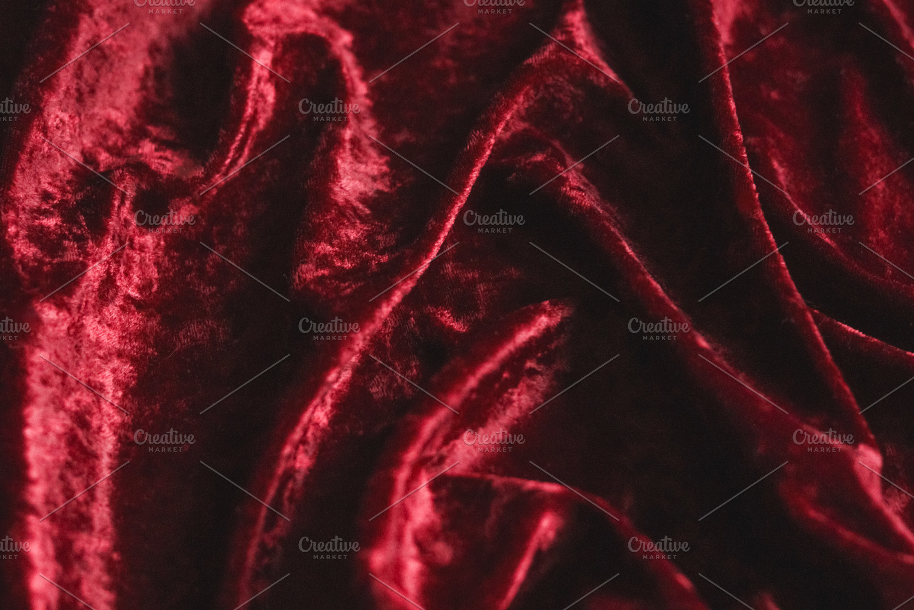Rich red velvet fabric creating soft, flowing drapes and luxurious texture back, a Photo by Studio ANNA