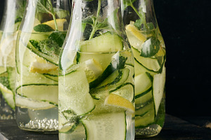 Gass bottles with red lids filled with detox water containing cu, a Food & Drink Photo by ndanko