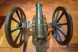 Old bronze cannon with wooden wheels indoors, an Arts & Entertainment Photo by DanFLCreativo