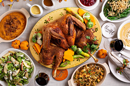 Thanksgiving dinner with whole turkey and sides, a Food & Drink Photo by farwasser