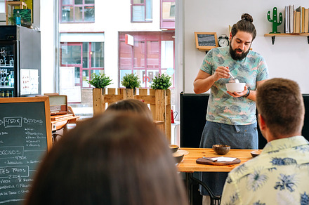 Young cook giving a cooking workshop, a Person Photo by davidpereiras