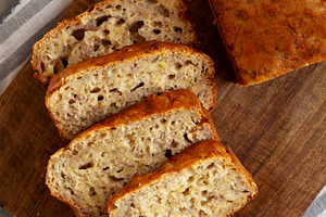 Homemade Banana Bread on a wooden board, top view. Close-up., a Food & Drink Photo by LiudmylaChuhunova
