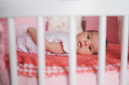 cute newborn baby lying in bed